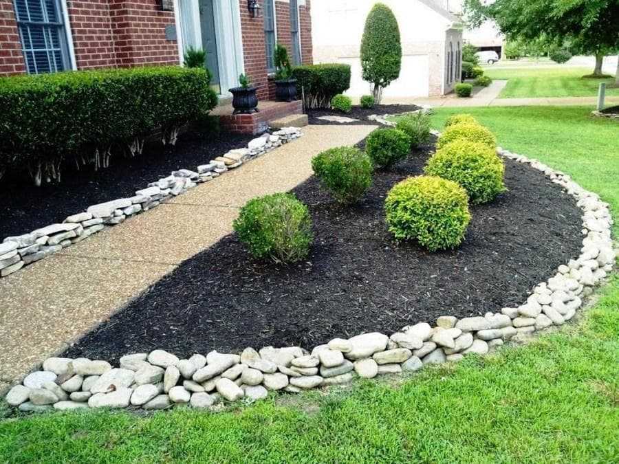 A beautifully landscaped garden with bushes and trim and edging in seattle washington